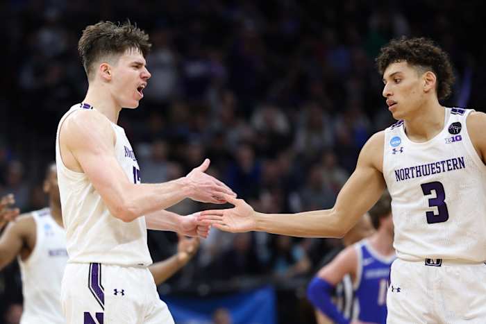 Northwestern Wildcats teammates Brooks Barnhizer and Ty Berry celebrate a win.